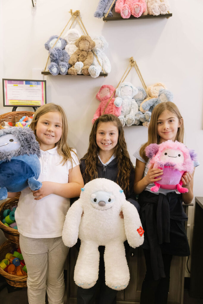 0O5A9715-Enhanced-NR group of elementary students pose with stuffed animals