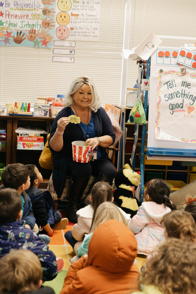 0O5A9898-Enhanced-NR teacher leads a group of students on rug through a lesson